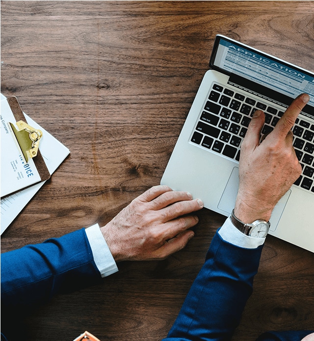 Man with computer completing financial application.